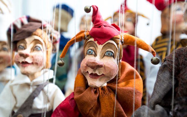 Carved wooden puppets dressed as jesters